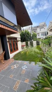 a house with a stone pathway in front of a building at Prantara in Dehradun