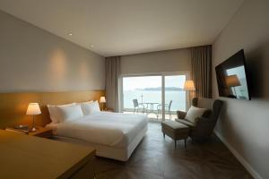 a hotel room with a bed and a table and chairs at Hotel Illua in Busan +219 photos