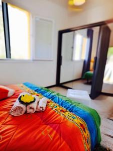 a bed with two dolls on it with a mirror at Guest House Safigumoru 5 minuti in spiaggia in Bari Sardo