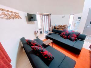 a living room with two couches and a table at Dome Planet Ocean's Seven / Vacation STAY 73132 in Teruma