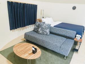 a living room with a couch and a table at Dome Planet Ocean's Seven / Vacation STAY 73132 in Teruma