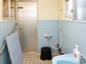 a blue tiled bathroom with a sink and a shower at Villa Ukishima - Vacation STAY 07308v in Naha