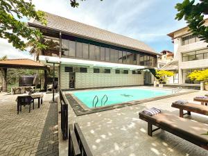 a swimming pool in front of a building at 3R Resort by Blue Bird in Negombo