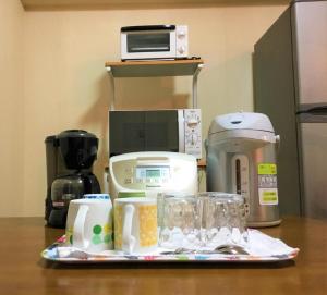 a counter with a coffee maker and other kitchen items at Weekly Harbourview Mansion Main Building / Vacation STAY 74562 in Naha +6 photos