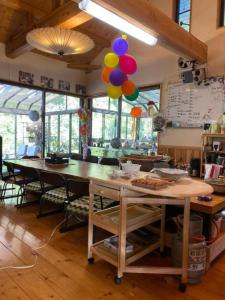 a room with a table with a bunch of balloons at Tsugoe's House Villa / Vacation STAY 74618 in Saijo