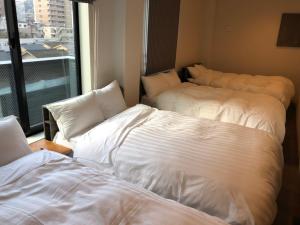 two beds in a room with a window at Time - Vacation STAY 18891v in Kagoshima