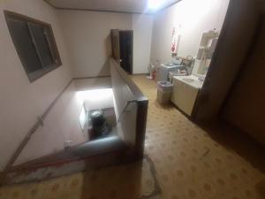 a small bathroom with a sink and a refrigerator at Hamburger restaurant Big foot / Vacation STAY 6626 in Hachinohe