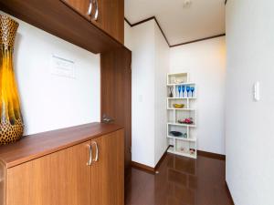 a room with a wooden door and a shelf at Sea Stay Okinawa / Vacation STAY 78095 in Onna +8 photos