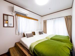 a bedroom with a large bed and a window at Sea Stay Okinawa / Vacation STAY 78095 in Onna