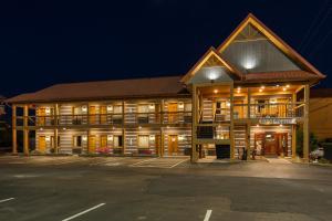 a large building with a parking lot in front of it at Timbers Lodge in Pigeon Forge