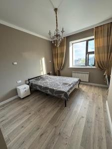 a bedroom with a bed and a large window at Brick house in Astana
