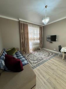 a living room with a bed and a large window at Brick house in Astana +13 photos