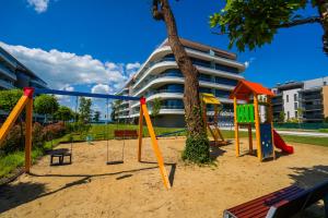 a playground in front of a building at MyFlat Wave Beach39 Apartment in Siófok
