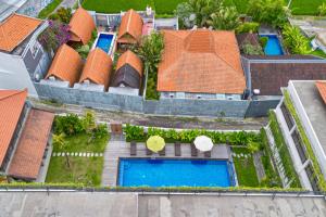 an aerial view of a house with swimming pools at Puri Kaja House in Badung +108 photos