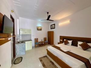 a hotel room with a bed and a tv at Ved Bhoomi residency in Rishīkesh