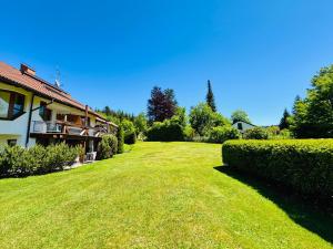 a large grassy yard next to a house at Siebert Apartment in Titisee-Neustadt
