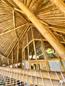 a large wooden ceiling with windows in a building at Hidden Bamboo Village in Selat