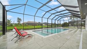 an indoor swimming pool with a glass roof at Modern Florida Escape in Rotonda West