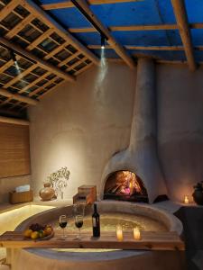 a living room with a fireplace with wine glasses at Twilight Cloud Spring Tree Private Hot Spring Homestay Bifengxia Panda Base Store in Ya'an