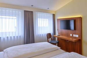 מיטה או מיטות בחדר ב-Hotel Apfelbaum