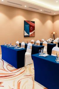 a conference room with blue tables and white chairs at Vias Hotel Vung Tau in Vung Tau +161 photos