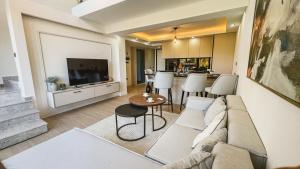 a living room with a couch and a kitchen at Palmera Resort Wellness & SPA in Kyrenia