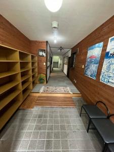 a hallway with wooden walls and a bench in a room at The Nook Hakuba in Hakuba +15 photos