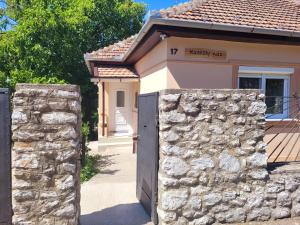 a gate to a house with a stone wall at Kastély Ház in Sály +27 photos