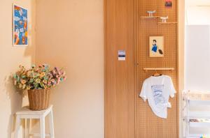 a room with a door and a vase of flowers at 오션드림스테이 in Busan