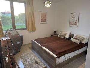 a bedroom with a bed with a fan and a window at Villa Rada, Bay View Villas in Kosharitsa +25 photos