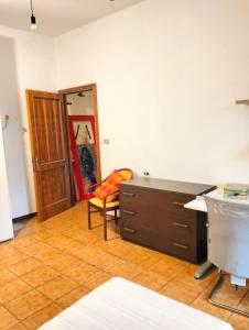 a room with a desk and a chair and a door at Casa dell'artista in Molino di Monte Urano
