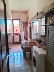 a kitchen with a sink and a washing machine at Casa dell'artista in Molino di Monte Urano