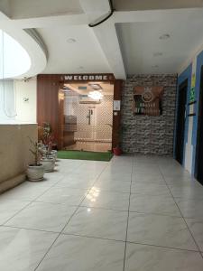 a hallway with a lobby with a welcome sign on the wall at Hotel RJ RESIDENCY in Jāmb