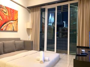 a living room with a couch and a large window at Seri bukit ceylon residency by An homes in Kuala Lumpur +13 photos