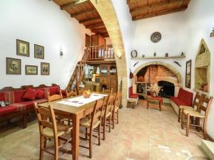 a living room with a wooden table and chairs at Villa in Crete with Vineyard Experience in Kalamítsion Alexándrou