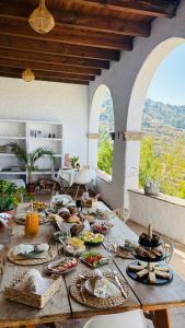 a table with food on it in a room with windows at Cortijo J&S Juan Salvador in Málaga