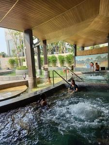 a group of people playing in a swimming pool at Lynn Times Thanh Thuỷ Hotel in Xuân Vi