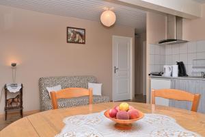 a bowl of fruit on a table in a kitchen at Gite Au Milieu Des Chevaux Mérens in Castelnau-Durban