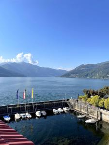 a dock with boats in a large body of water at Attico vista Lago in Centro in Luino