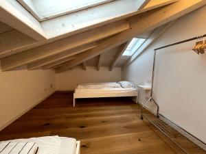 a attic room with a bed and a window at Attico vista Lago in Centro in Luino