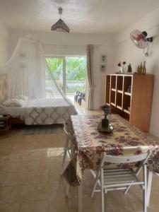 a bedroom with a table and a bed with a window at Pointe Aux Biches Villa in Pointe aux Biches