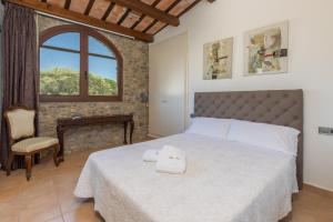 a bedroom with a large bed and a window at casa rural de ensueño in Sant Gregori +39 photos