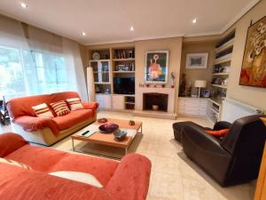 a living room with two couches and a fireplace at Precioso chalet 4 habitaciones con Piscina comunitaria in Benicàssim