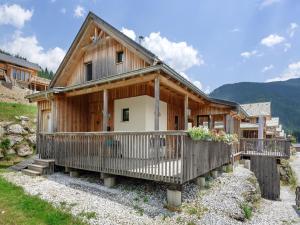 a wooden house with a balcony in the mountains at Holzchalet nahe Skilift Hohentauern in Hohentauern