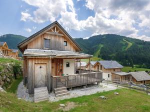 a wooden house with a balcony in a village at Holzchalet nahe Skilift Hohentauern in Hohentauern