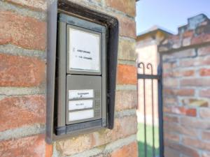 a pay phone is attached to a brick wall at Tranquil Stay in Montepulciano in Acquaviva