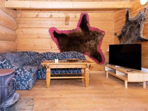 a living room with a couch and a tv at 8 person holiday home in Ebeltoft in Ebeltoft