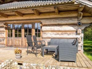a patio with chairs and a table on a wooden deck at 8 person holiday home in Ebeltoft in Ebeltoft