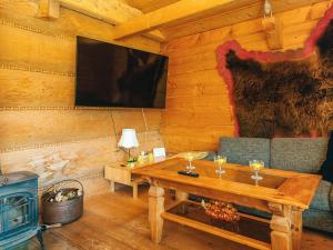 a living room with a table and a stove at 8 person holiday home in Ebeltoft in Ebeltoft