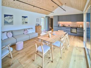 a kitchen and living room with a wooden table and chairs at Chalet Hochsteiermark in Mariazell